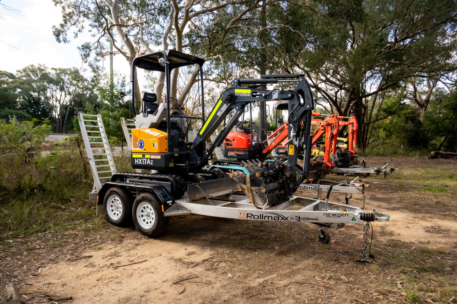 Hyundai HX17Az 1.7 tonne mini excavator on a trailer with the rest of the fleet behind